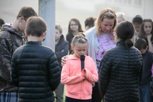 NCA student in prayer