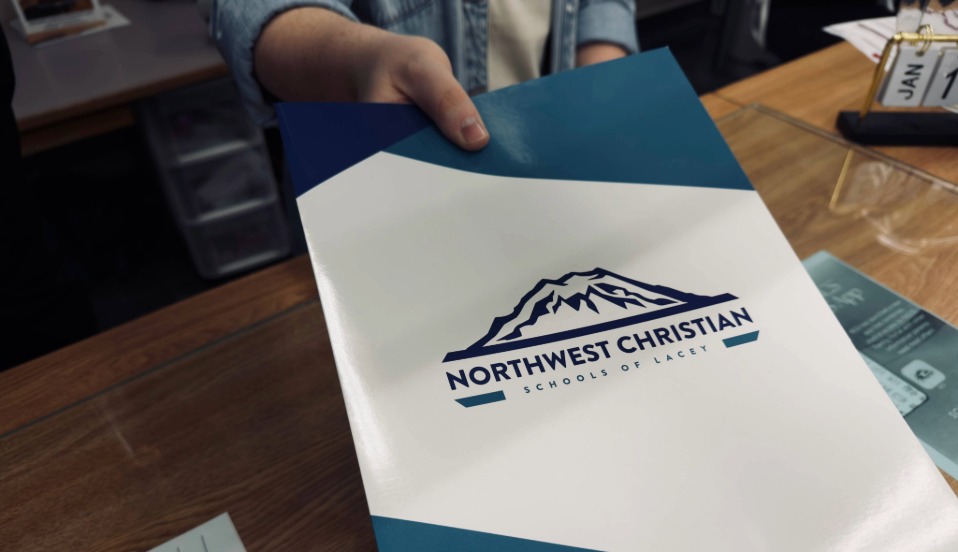 Students, parents and teachers praying at the flagpole